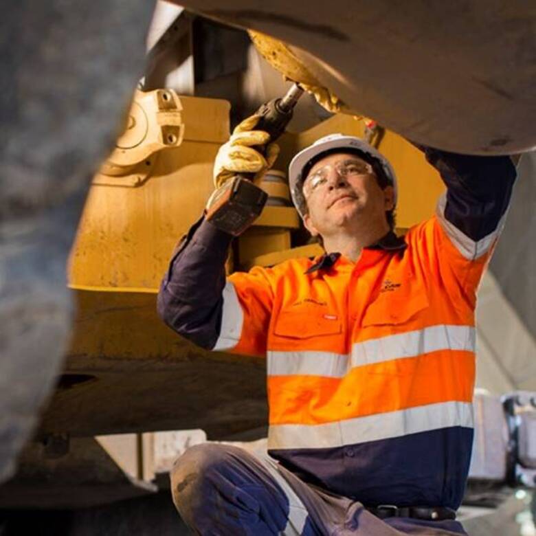 Maintenance working in an orange safety vest