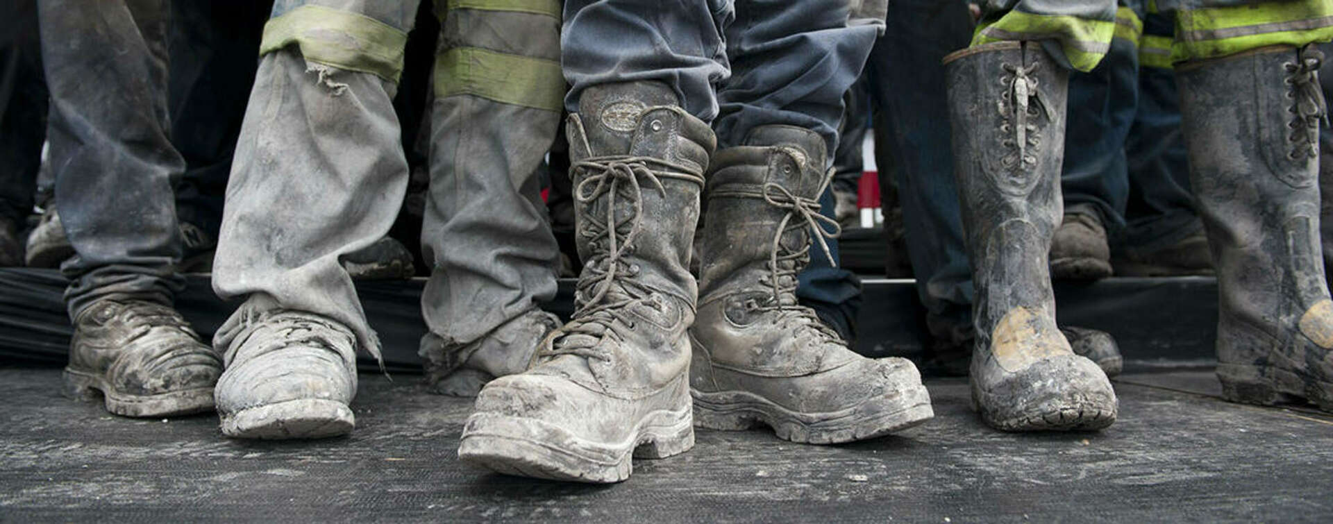photo of construction workers feet in muddy boots
