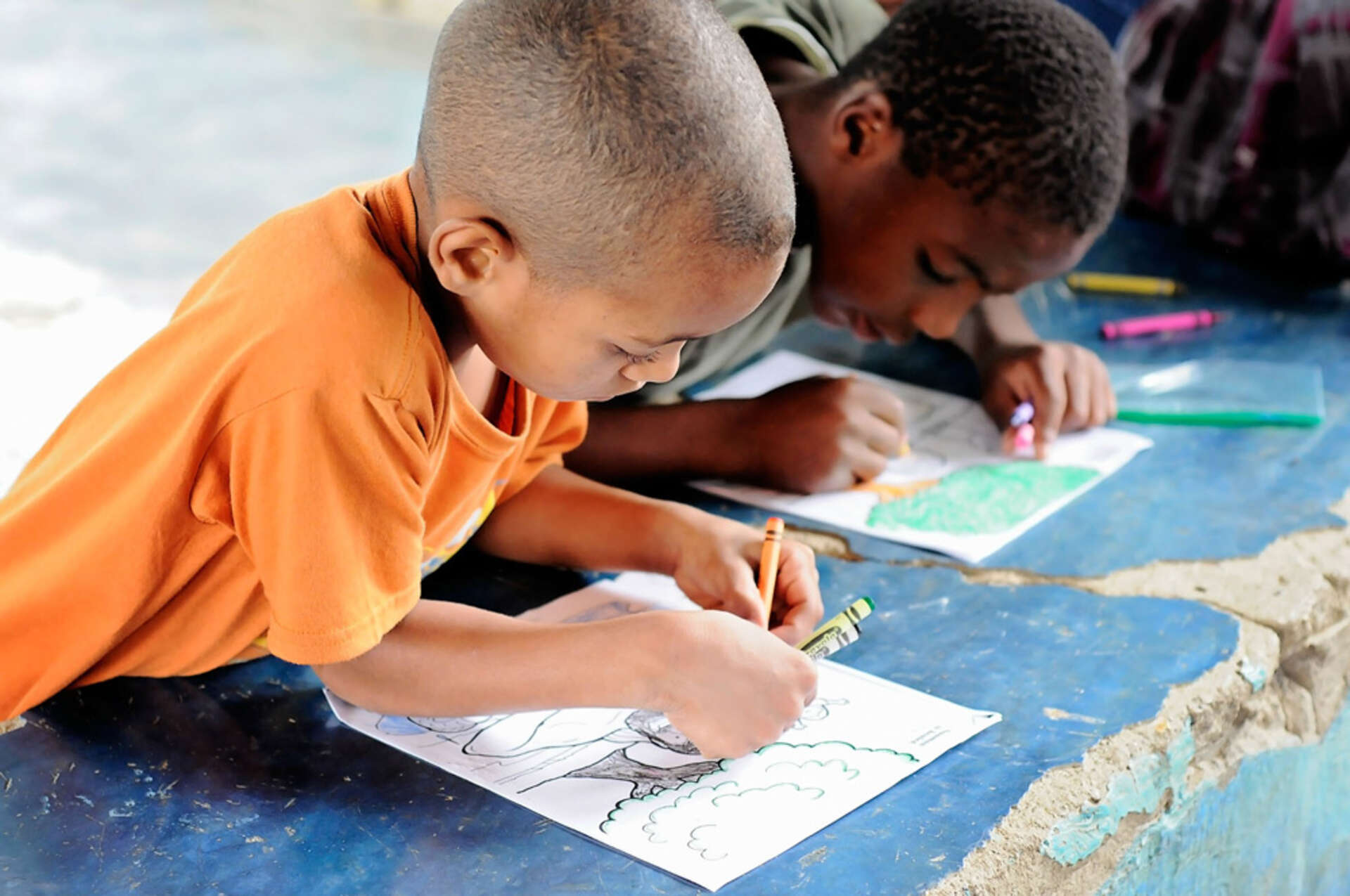 Young Dominican boys colouring
